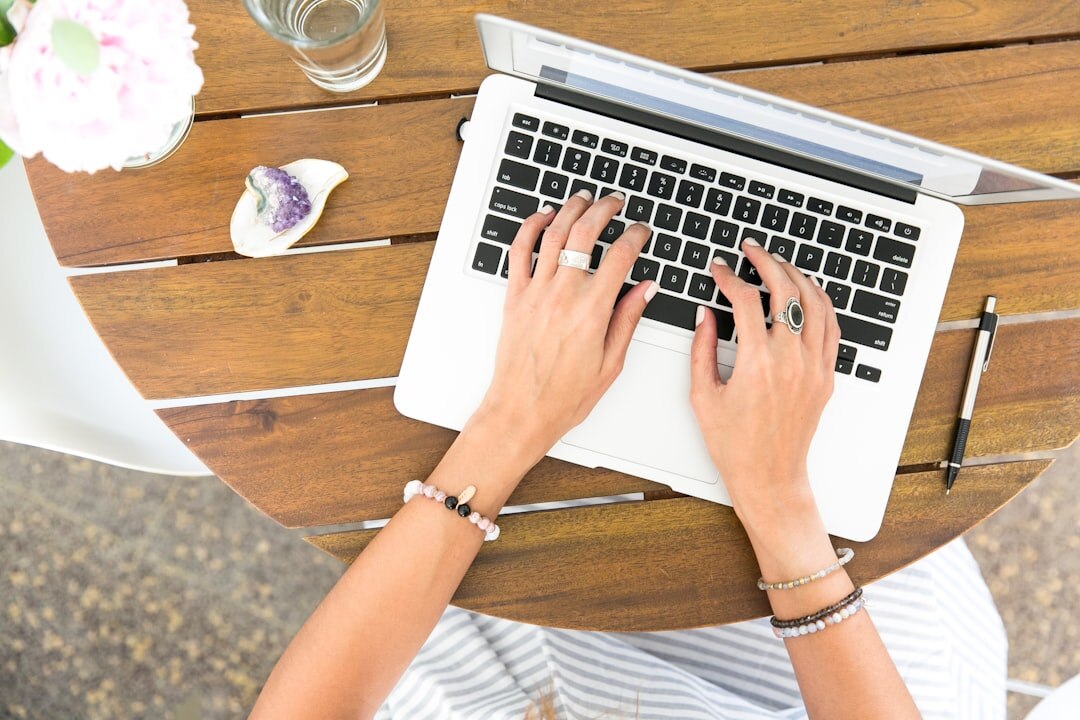 writer typing on laptop